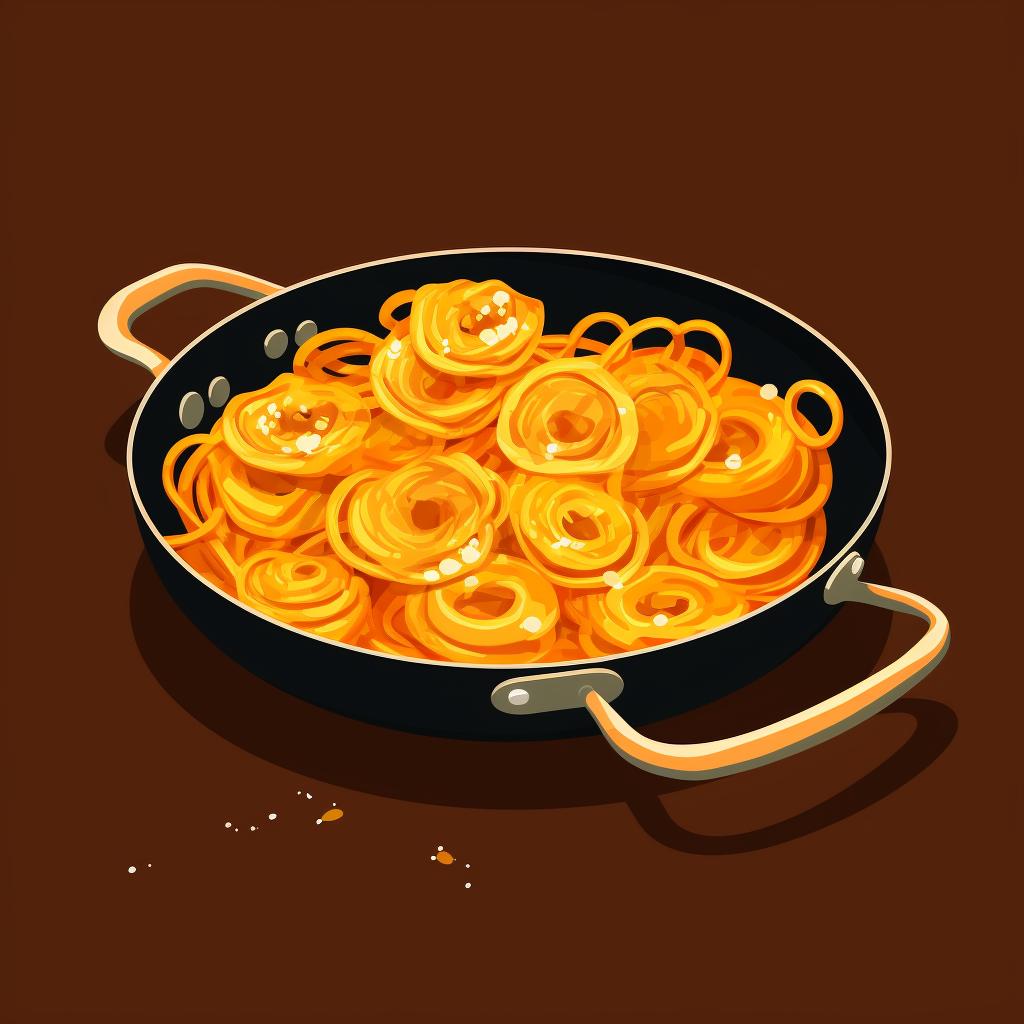 Jalebi evenly spread out in a pan.